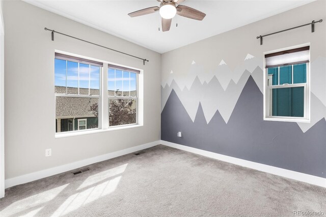 carpeted empty room with ceiling fan