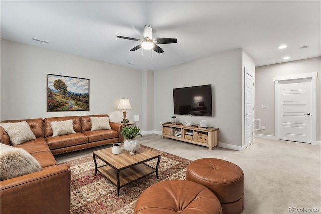 carpeted living room with ceiling fan