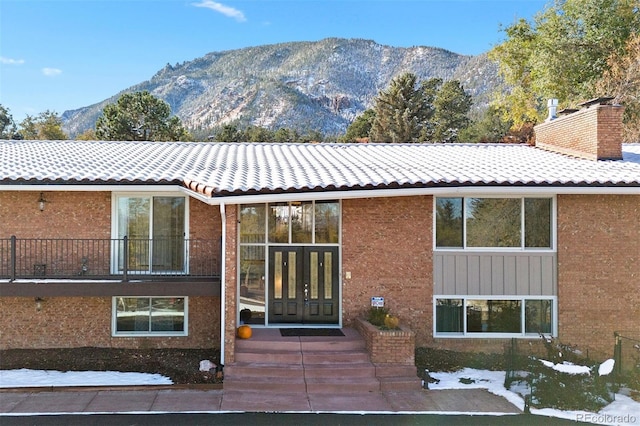 exterior space featuring a mountain view and a balcony