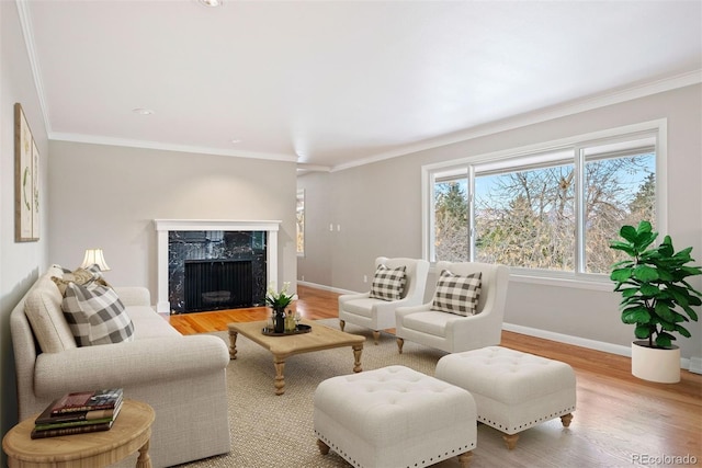 living room with wood-type flooring, a premium fireplace, and crown molding