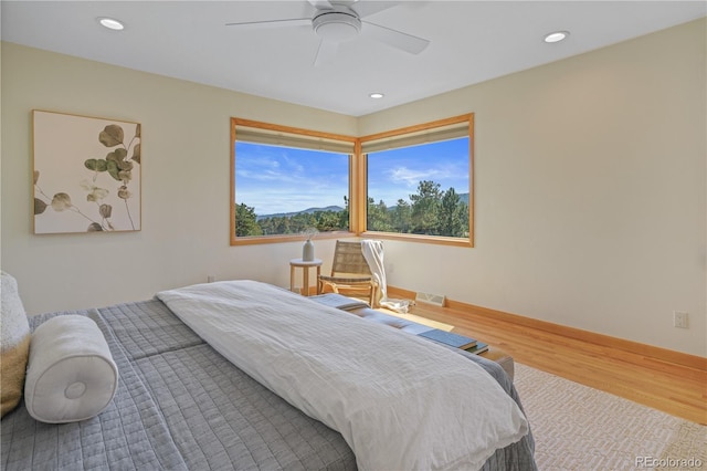 bedroom with hardwood / wood-style flooring and ceiling fan