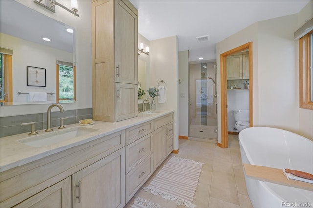 full bathroom with separate shower and tub, tile patterned flooring, vanity, and toilet