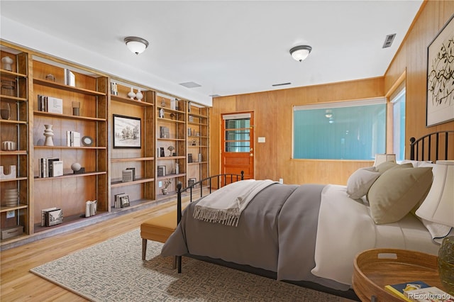 interior space featuring hardwood / wood-style floors, built in features, a wealth of natural light, and wood walls