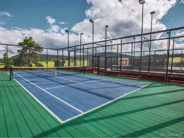 view of sport court with basketball hoop