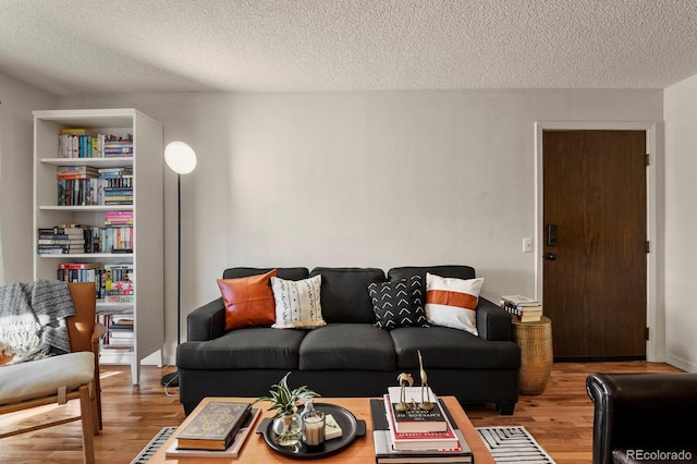 living area featuring a textured ceiling and wood finished floors