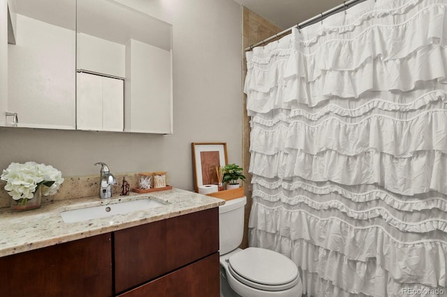 bathroom with vanity, a shower with curtain, and toilet