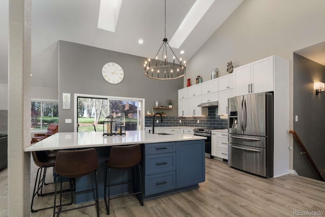 2539 Lake Meadow Dr, Lafayette, CO 80026 - kitchen featuring stainless steel appliances, high vaulted ceiling, a sink, a skylight, and a chandelier