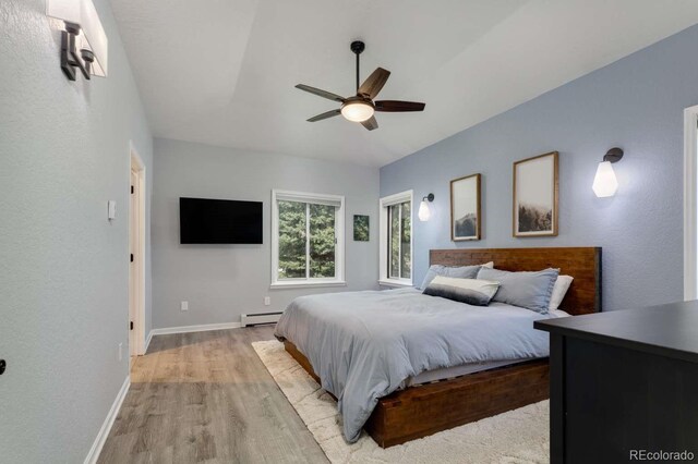 2539 Lake Meadow Dr, Lafayette, CO 80026 - bedroom featuring light wood-style floors, a baseboard heating unit, baseboards, and a ceiling fan