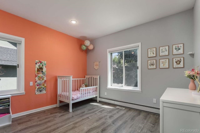 2539 Lake Meadow Dr, Lafayette, CO 80026 - bedroom with wood finished floors, a baseboard heating unit, recessed lighting, and baseboards