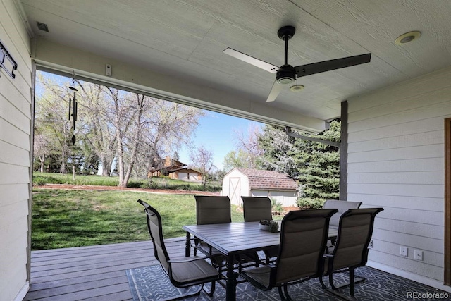 2539 Lake Meadow Dr, Lafayette, CO 80026 - wooden deck with outdoor dining area, a shed, a lawn, an outdoor structure, and a ceiling fan