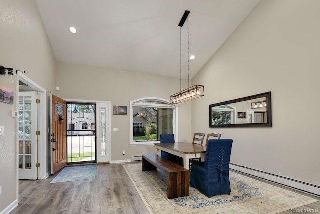 2539 Lake Meadow Dr, Lafayette, CO 80026 - dining area featuring baseboard heating, wood finished floors, high vaulted ceiling, baseboards, and recessed lighting