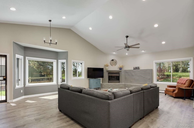 2539 Lake Meadow Dr, Lafayette, CO 80026 - living room with recessed lighting, light wood-style floors, ceiling fan, a glass covered fireplace, and a chandelier