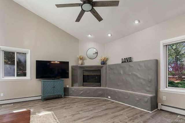 2539 Lake Meadow Dr, Lafayette, CO 80026 - unfurnished living room featuring a baseboard heating unit, lofted ceiling, a ceiling fan, wood finished floors, and recessed lighting