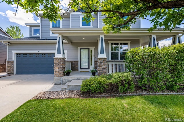 902 Jarvis Dr, Erie, CO 80516 - view of front of home with a porch, a garage, stone siding, and driveway