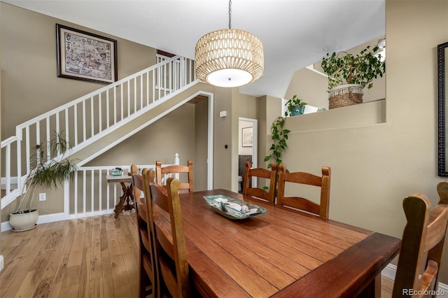 902 Jarvis Dr, Erie, CO 80516 - dining space featuring wood-type flooring, stairs, and a chandelier