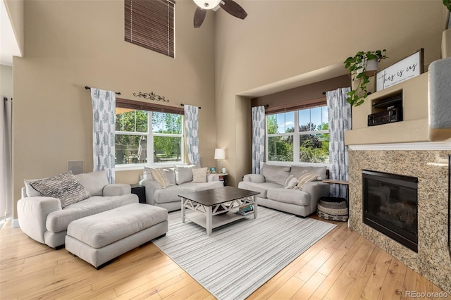 902 Jarvis Dr, Erie, CO 80516 - living area featuring ceiling fan, a towering ceiling, hardwood / wood-style flooring, and healthy amount of natural light