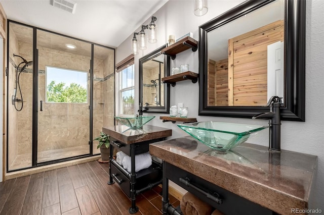 902 Jarvis Dr, Erie, CO 80516 - bathroom featuring a shower stall, vanity, and wood finished floors