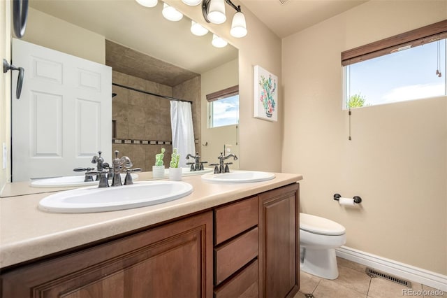 902 Jarvis Dr, Erie, CO 80516 - full bath featuring toilet, double vanity, tile patterned floors, tiled shower, and baseboards