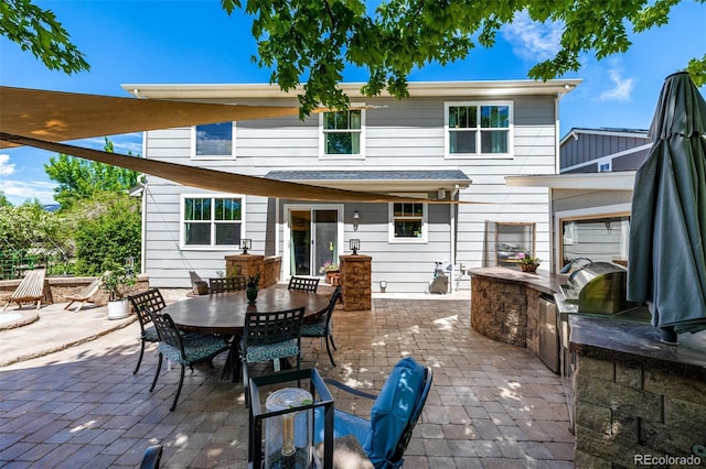 902 Jarvis Dr, Erie, CO 80516 - rear view of property featuring a patio, exterior kitchen, and outdoor dining area