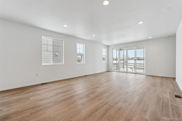 spare room with light hardwood / wood-style floors