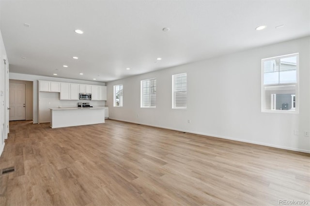 unfurnished living room featuring light hardwood / wood-style flooring