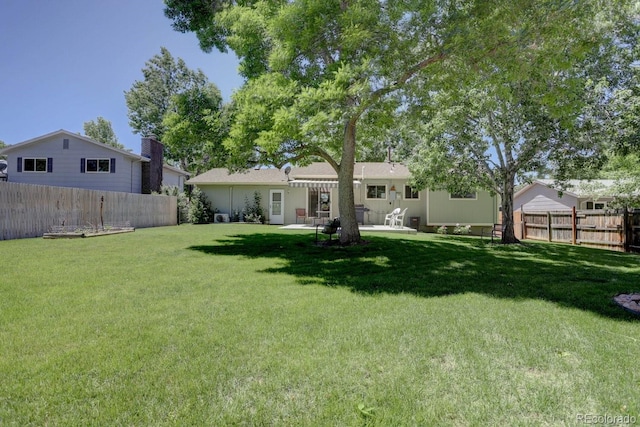 view of yard featuring a patio area and a fenced backyard