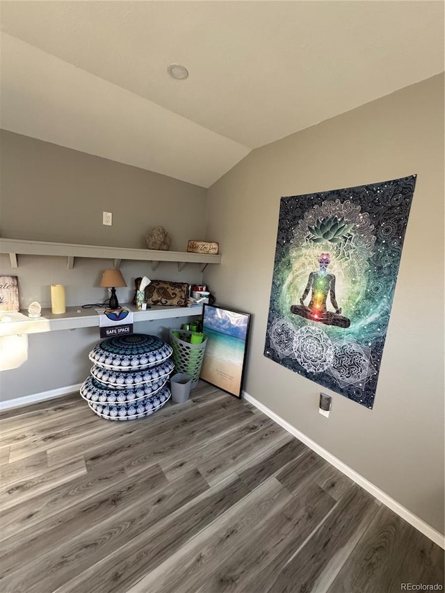 interior space featuring baseboards and wood finished floors