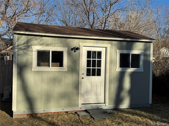 view of outbuilding with an outbuilding and fence