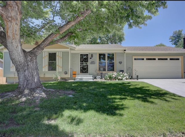 ranch-style home with a garage, a front yard, and driveway