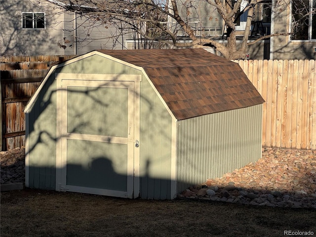 view of shed featuring fence