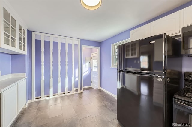 kitchen featuring white cabinets and black appliances