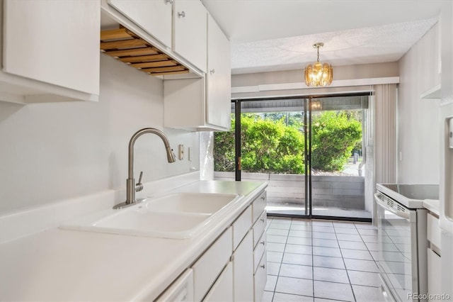 6490 S Dayton St Unit L02, Englewood, CO 80111 - kitchen with white electric stove, white cabinetry, light tile patterned flooring, light countertops, and pendant lighting