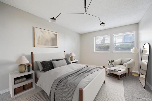 6490 S Dayton St Unit L02, Englewood, CO 80111 - bedroom featuring light colored carpet and a textured ceiling