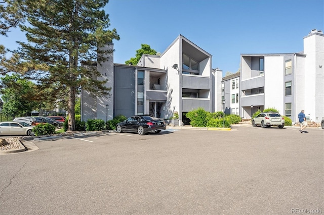 6490 S Dayton St Unit L02, Englewood, CO 80111 - view of apartment building / complex with uncovered parking