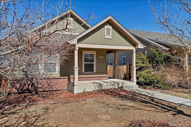 view of front facade with a porch, board and batten siding, and brick siding