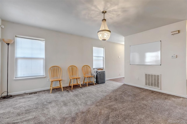 sitting room with carpet, visible vents, and baseboards