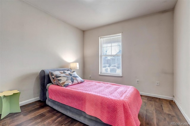 bedroom with baseboards and wood finished floors