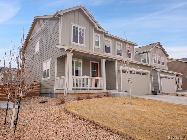 view of front of home featuring a garage, board and batten siding, covered porch, and concrete driveway