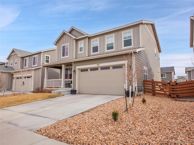 view of front of property featuring an attached garage, board and batten siding, fence, covered porch, and driveway