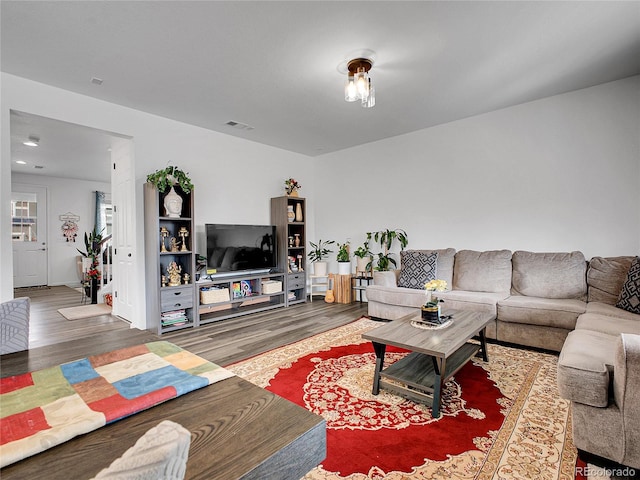 living area with wood finished floors and visible vents