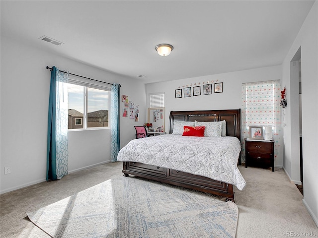 bedroom with light colored carpet, baseboards, and visible vents