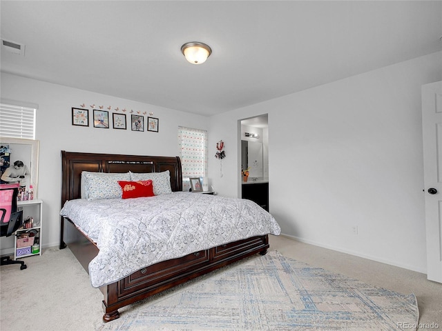 bedroom featuring light colored carpet, visible vents, ensuite bathroom, and baseboards
