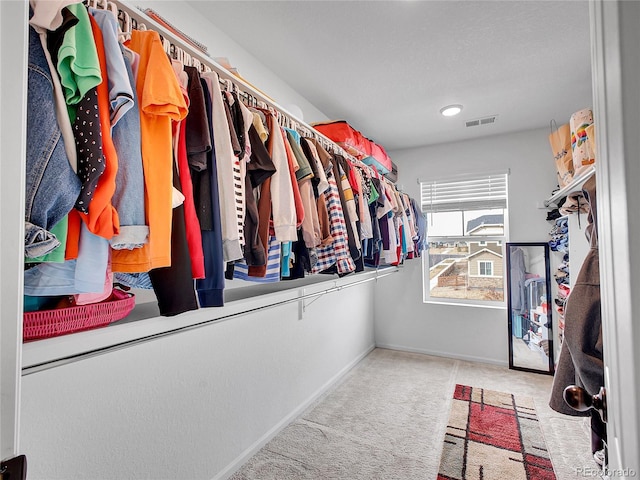 spacious closet with visible vents and carpet flooring