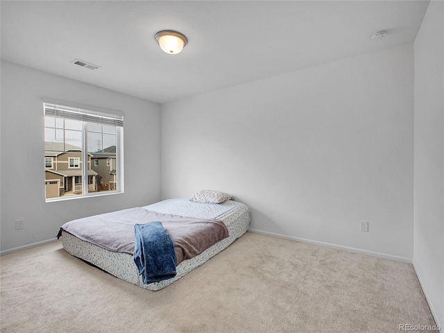 bedroom featuring visible vents, baseboards, and carpet