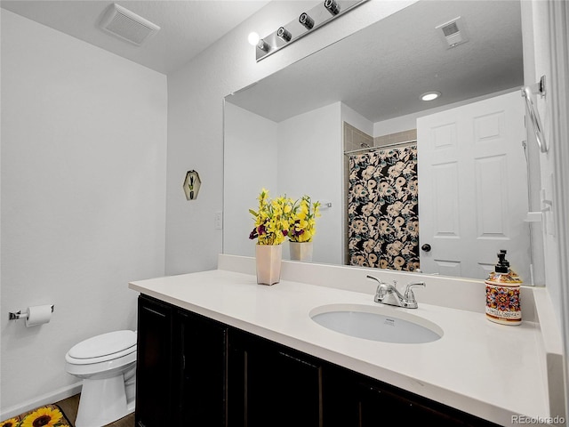 bathroom with visible vents, toilet, vanity, and a shower with shower curtain
