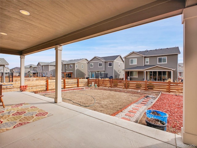 view of patio / terrace featuring a residential view and fence
