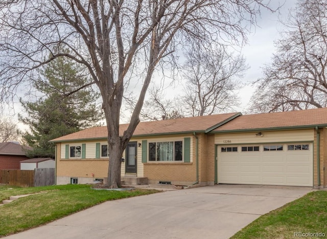 ranch-style home with a front yard, a garage, fence, concrete driveway, and brick siding