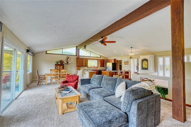 living room featuring light carpet, vaulted ceiling with beams, and ceiling fan