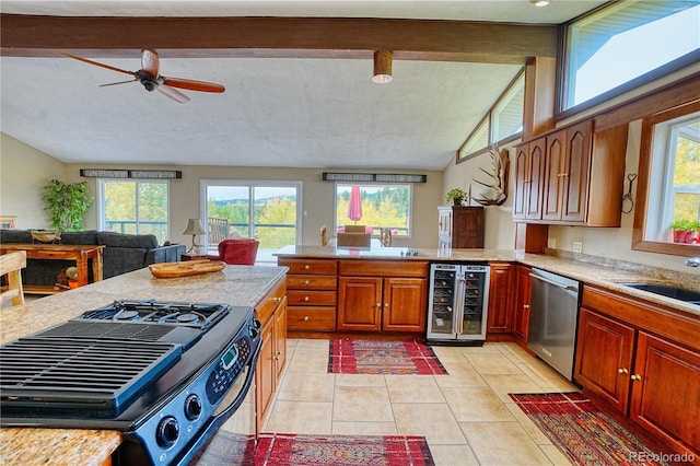 kitchen with wine cooler, plenty of natural light, light tile patterned floors, and dishwasher