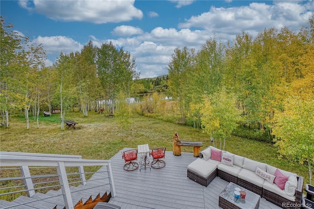 wooden deck with a lawn and an outdoor living space with a fire pit